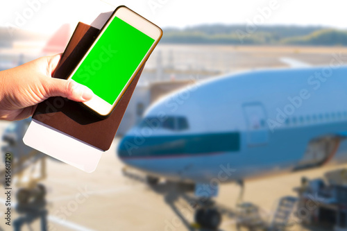 Smartphone, boarding pass, passport, terminal, airplane in travel concept.