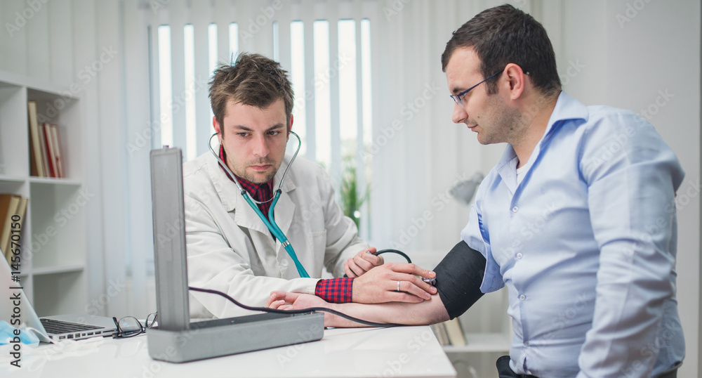 Doctor cardiologist examining his patient at the hospital Doctor cardiologist examining his patient at the hospital