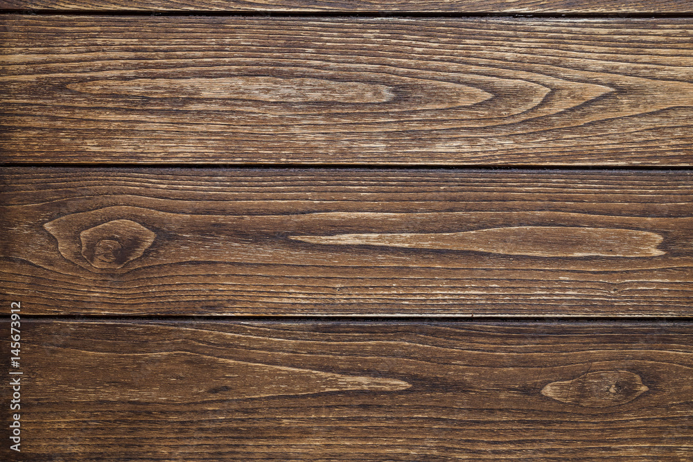 Background of three horizontal boards of dark wood with knots and traces of processing Background of three horizontal boards of dark wood with knots and traces of processing
