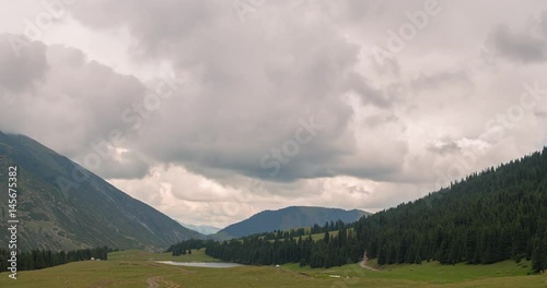 Clouds over the mountains. Grigoriev gorge, Issyk-Kul, Kyrgyzstan. Zoom. Time Lapse. 4K photo