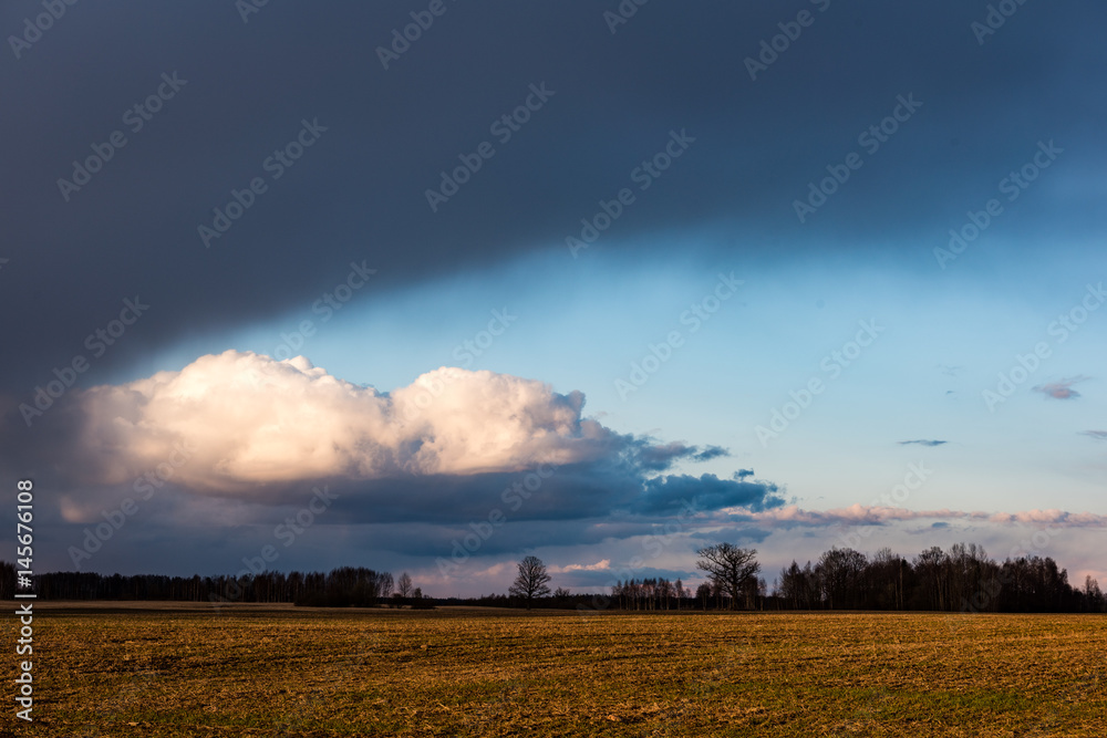 fields in country under blue sky with white clouds fields in country under blue sky with white clouds