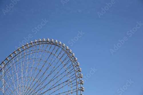 Ferris Wheel Over Blue Sky