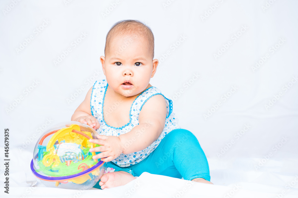 little thai baby playing toy on white background little thai baby playing toy on white background