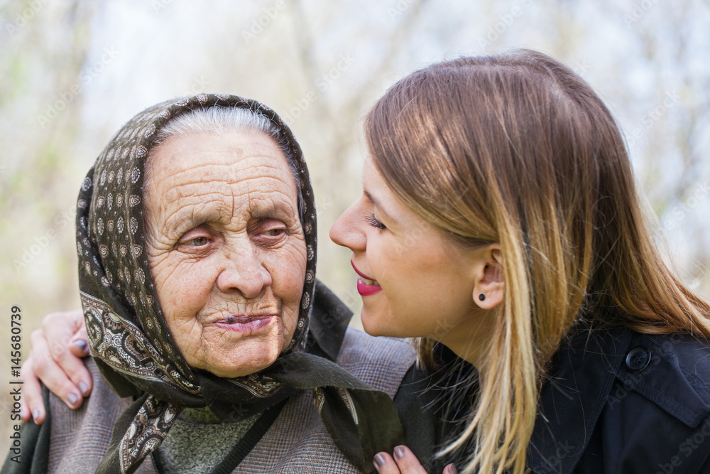 Young woman kissing her sick grandmother