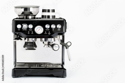 Isolated black manual coffee maker with coffee mug on a white background, front view