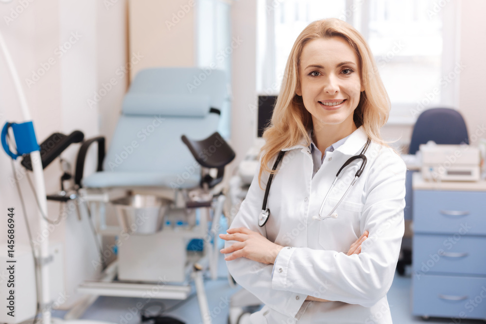 Cheerful gynecologist waiting for the next patient in the cabinet Cheerful gynecologist waiting for the next patient in the cabinet