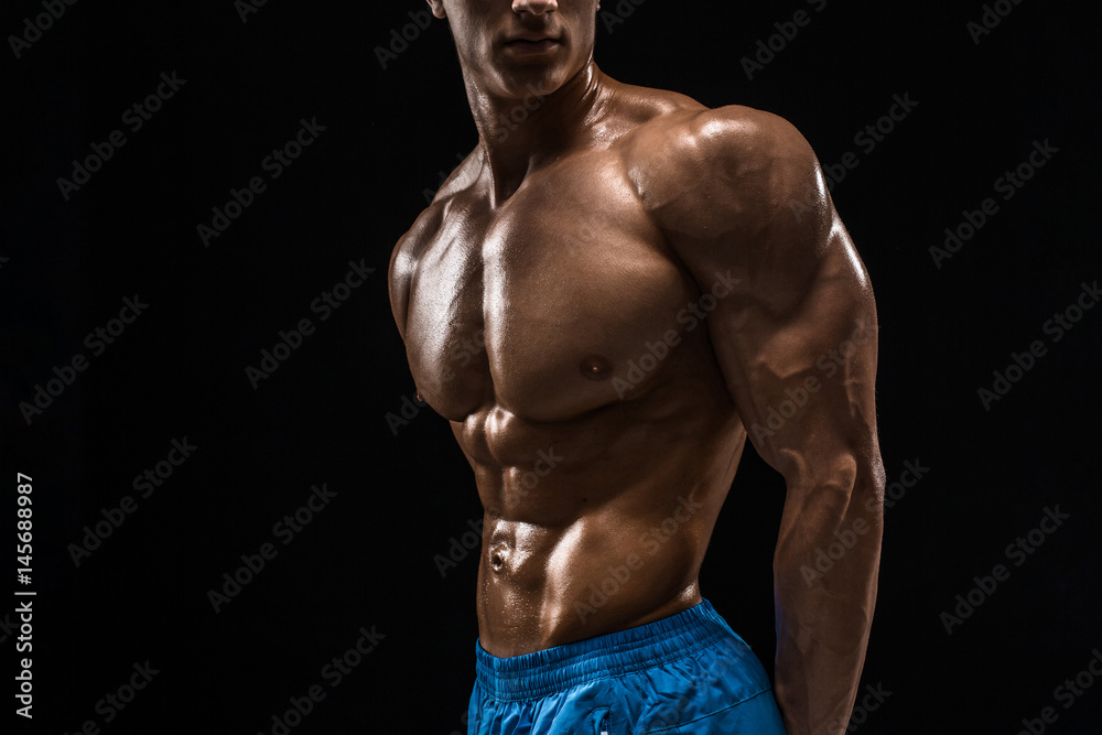 Fototapeta premium Part of a man's body on a dark background with copyspace