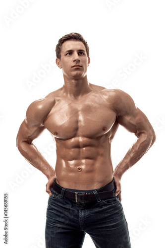 Muscular handsome young man with naked torso. Isolated on white background.