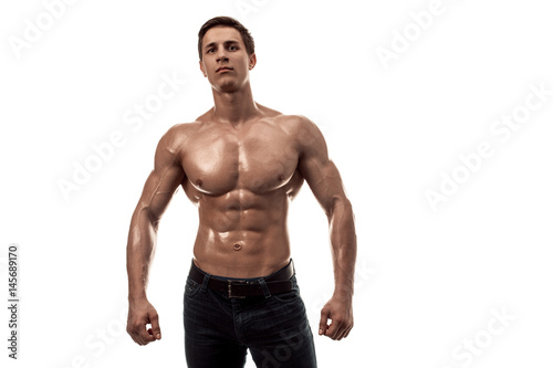 Muscular handsome young man with naked torso. Isolated on white background. Copy space