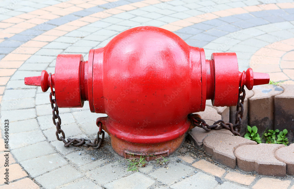 Red fire hydrant on a sidewalk.