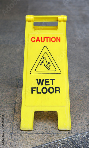 Sign advising caution on wet floor