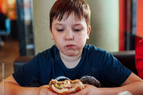 Boy does not like hamburger