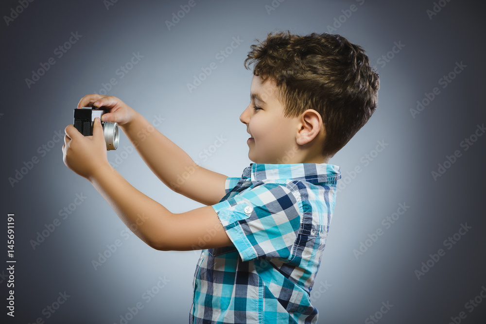 child making selfie using a retro rangefinder camera isolated grey background child making selfie using a retro rangefinder camera isolated grey background