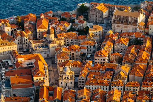 View from above on red tile on the roofs of houses and Assumption Cathedral in the old town in Dubrovnik, Croatia. photo