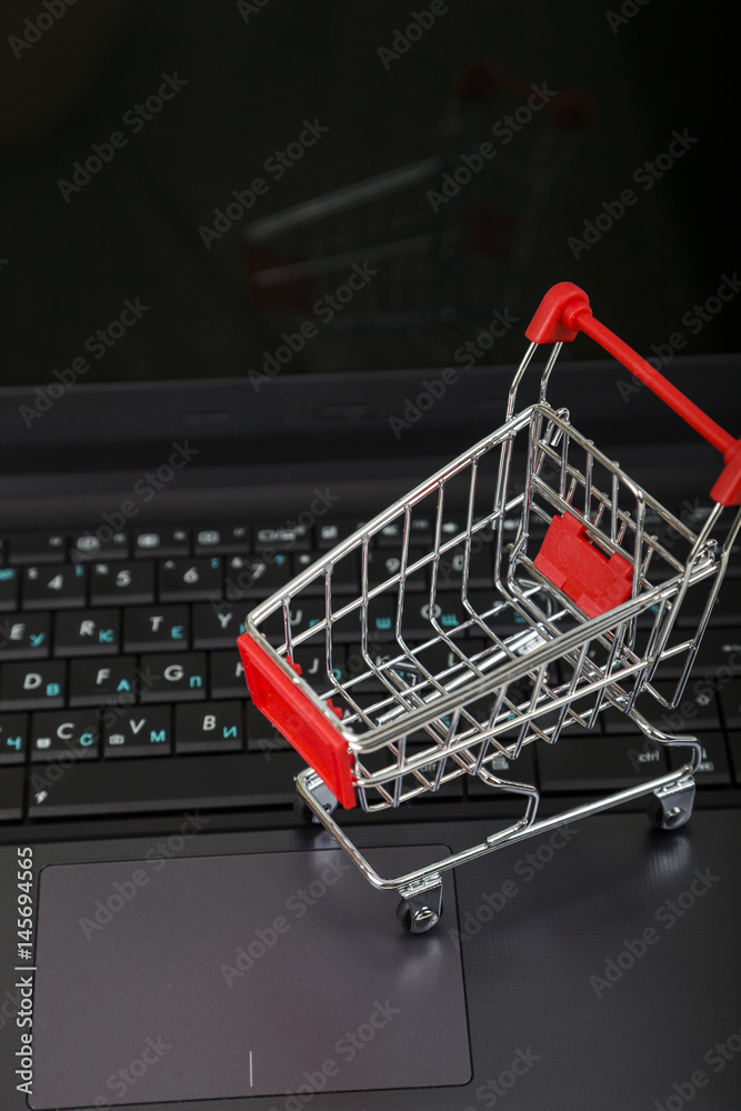 Shopping basket on a laptop. Concept of shopping online.