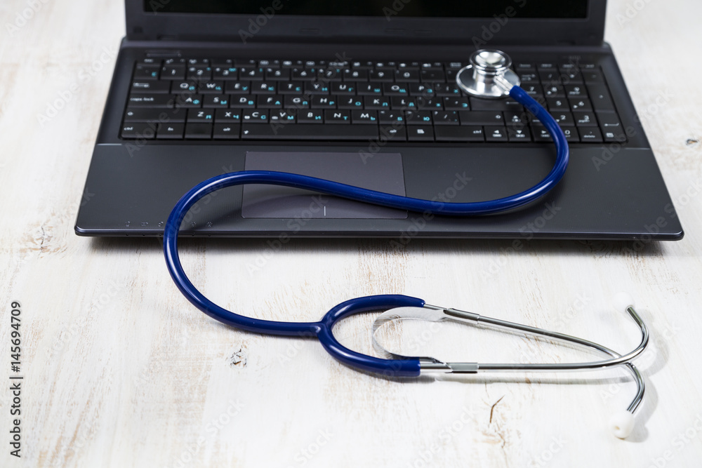 Health care concept. Stethoscope on a laptop Health care concept. Stethoscope on a laptop