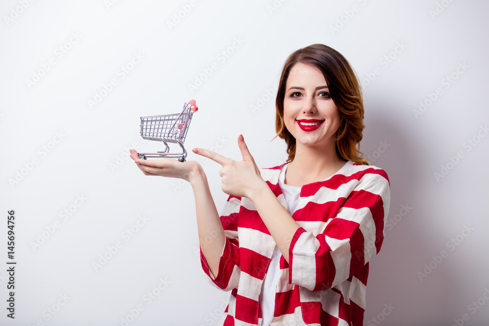 portrait of beautiful young woman with shopping cart on the wonderful white studio background portrait of beautiful young woman with shopping cart on the wonderful white studio background