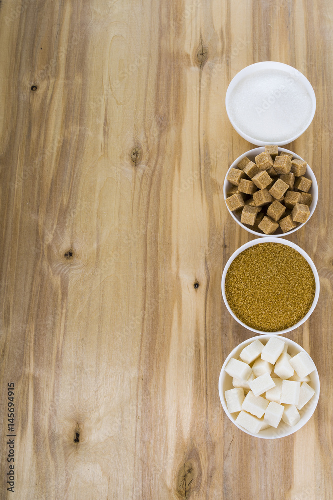 Different kind of white and brown sugar on old brown table Different kind of white and brown sugar on old brown table