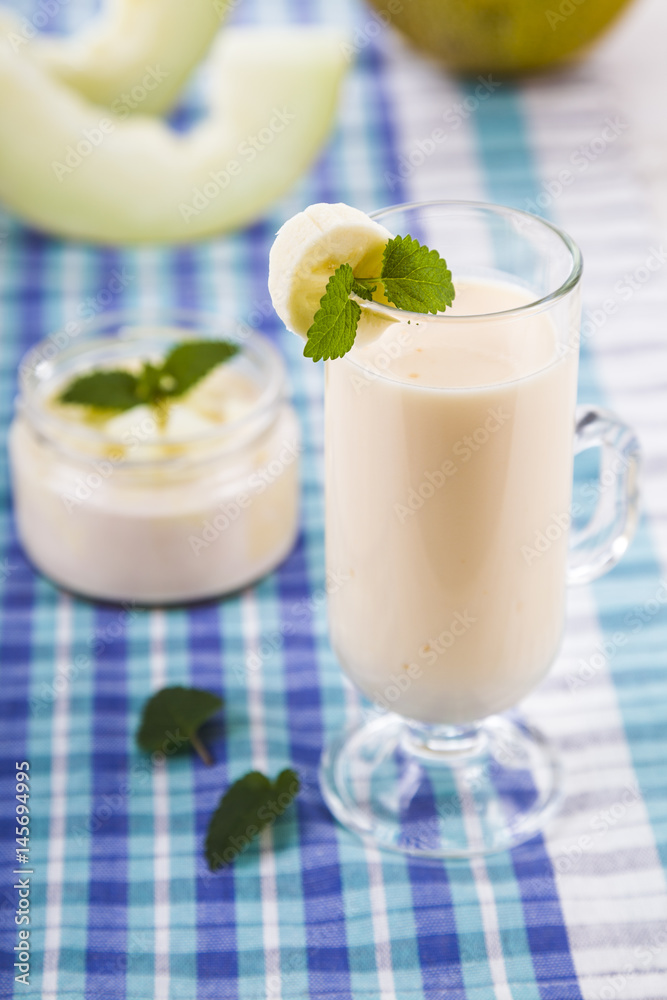 Smoothie with melon on a wooden table. Smoothie with melon on a wooden table.