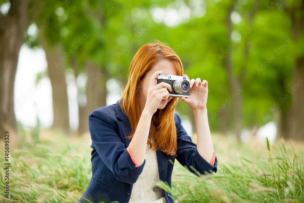 portrait of beautiful young woman holding retro camera on the wonderful park background portrait of beautiful young woman holding retro camera on the wonderful park background