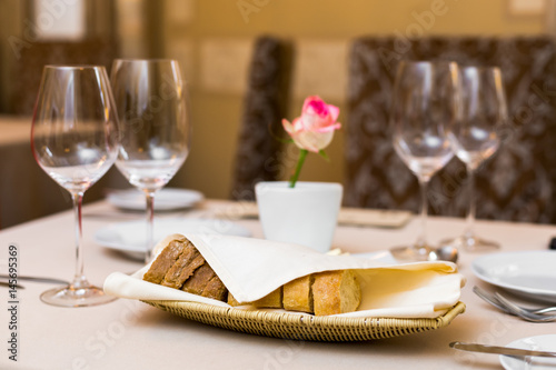 Beautifully decorated table in the restaurant. On the table is a plate of bread