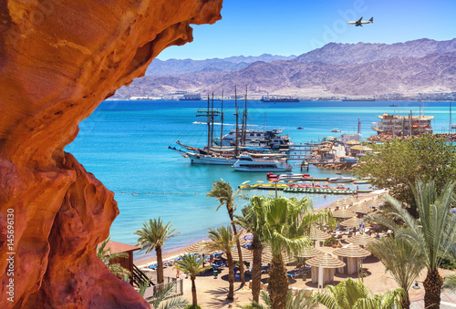 Image with central public beach of Eilat - famous resort city in Israel. Image symbolizes vacation, resting and recreation 
 photo