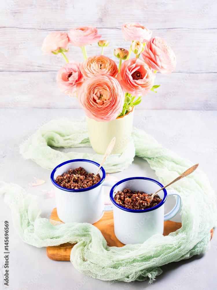 Red quinoa with vegetables in enamel mugs. Vegetarian gluten free lunch Red quinoa with vegetables in enamel mugs. Vegetarian gluten free lunch