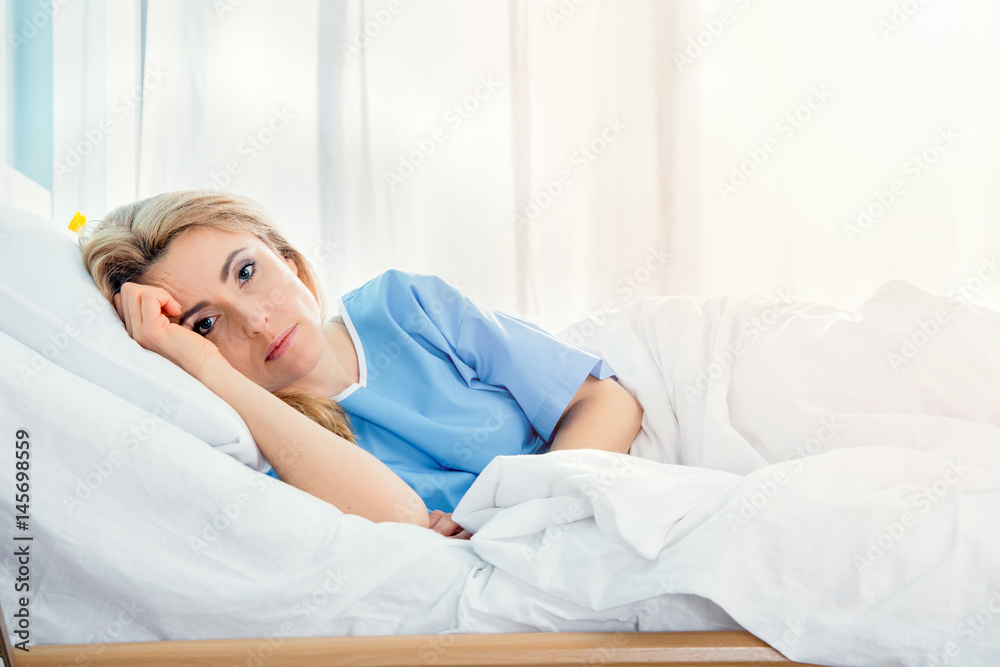 portrait of serious woman lying in hospital bed portrait of serious woman lying in hospital bed
