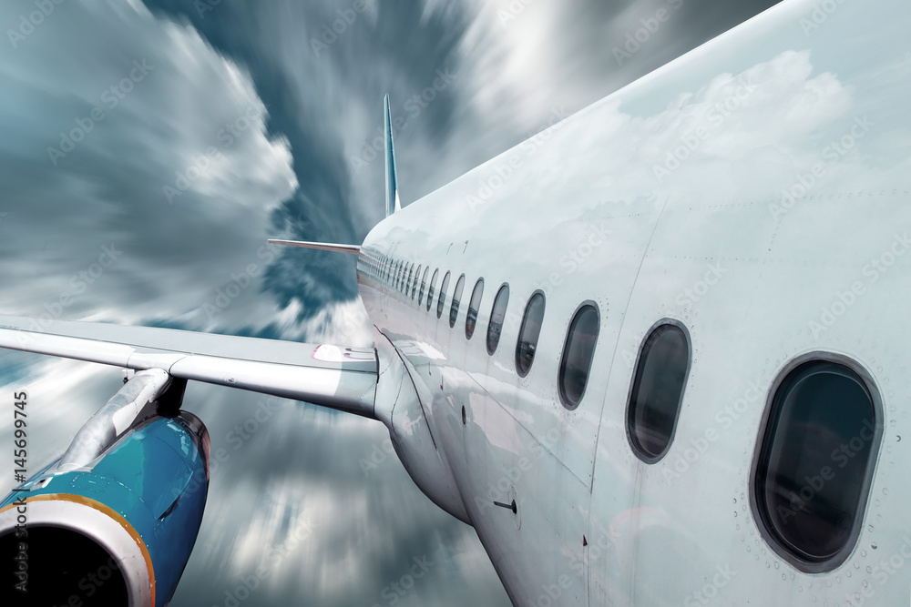 Fototapeta premium Airplane at fly on the sky with clouds