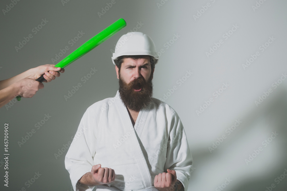 bearded shouting karate man in kimono, helmet with baseball bat bearded shouting karate man in kimono, helmet with baseball bat