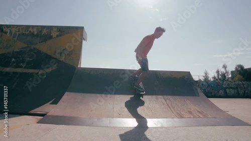 The skateboardist is skating in the ramp in the skateboarding park.HD photo