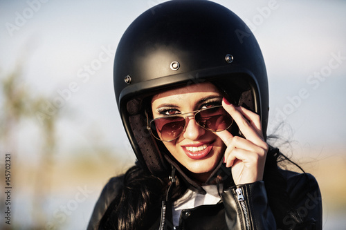 Beautiful brunette woman with a classic motorcycle (cinema bleach bypass effect) © czamfir