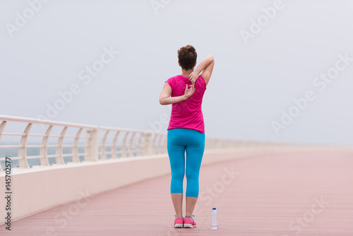 woman stretching and warming up on the promenade