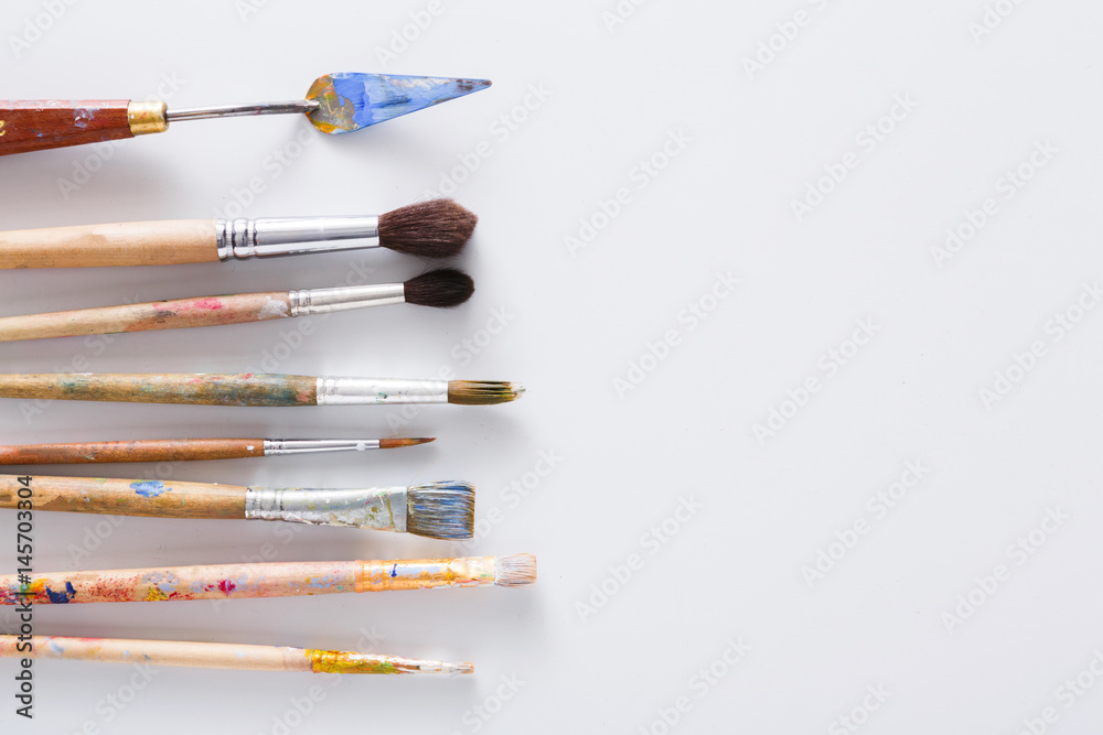 Drawing tools, set of dirty paint brushes in row