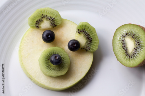 close up of bear face made of fruits
