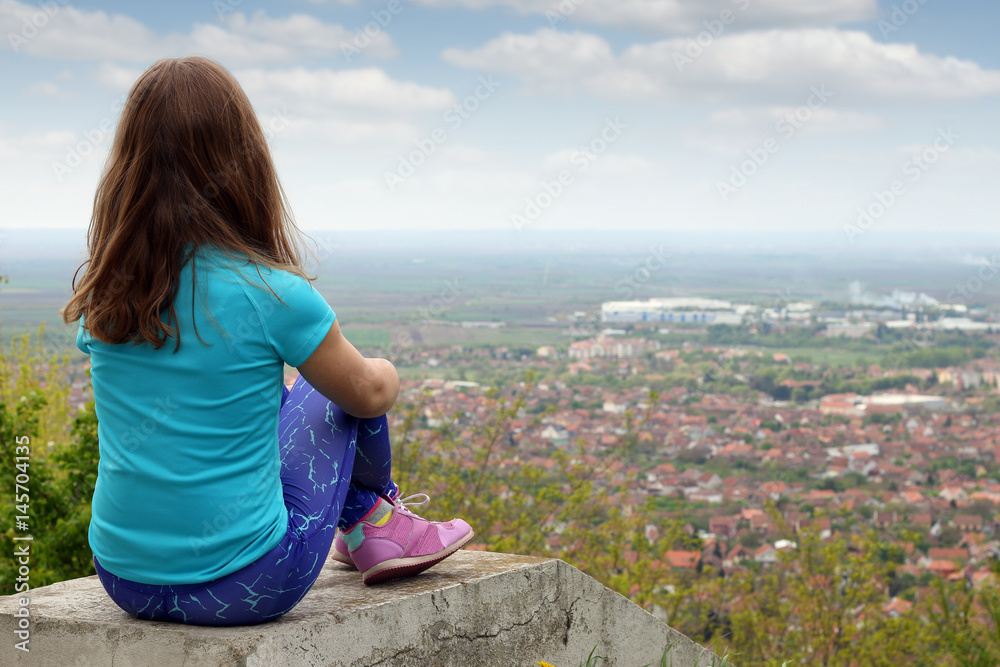 little girl looking at the city