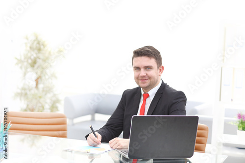 Young employee looking at computer monitor during working day