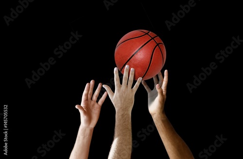 Players hand reaching for basketball in a competition © razihusin