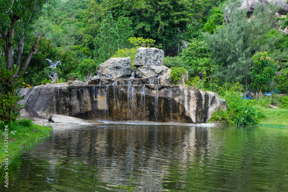 Waterfall and a lake in a park at Orchid Island, Vietnam