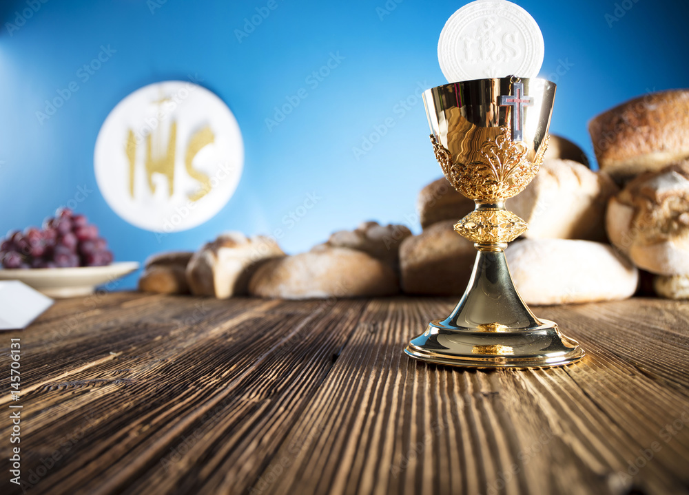 First Holy communion. Catholic theme. Crucifix, chalice, bible, bread on  rustic wooden table and blue background. Stock Photo | Adobe Stock