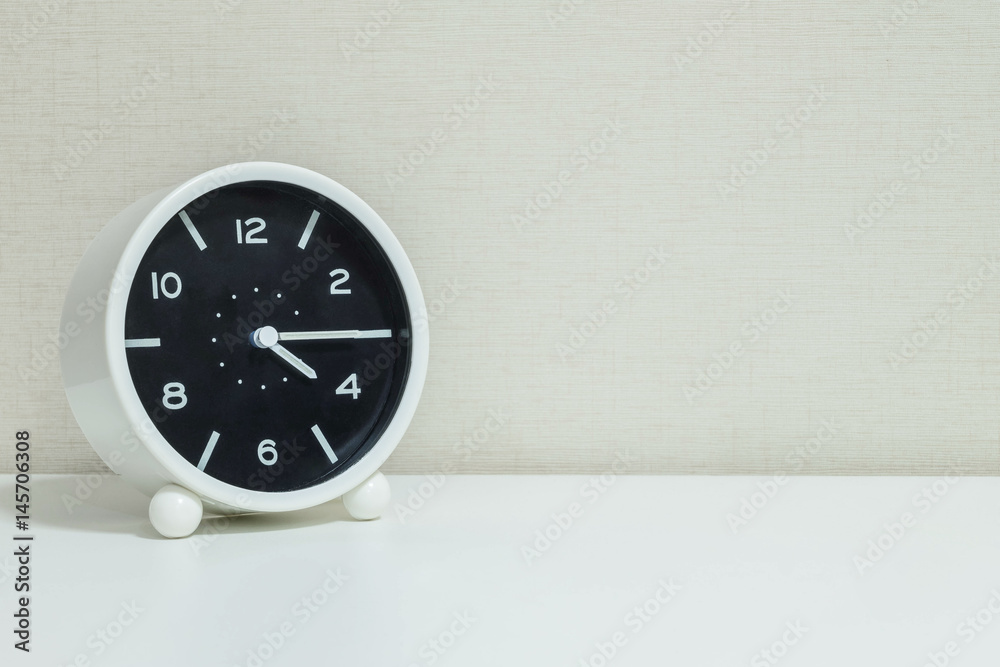 Closeup black and white alarm clock for decorate show a quarter past