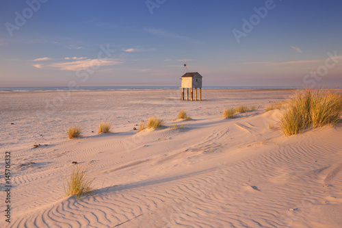 Refuge hut on Terschelling island in The Netherlands at sunset photo