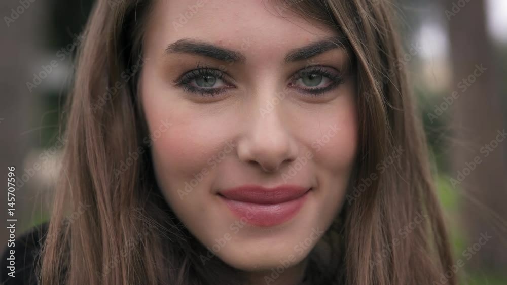 beautiful young woman smiling sensually at the camera,close up beautiful young woman smiling sensually at the camera,close up