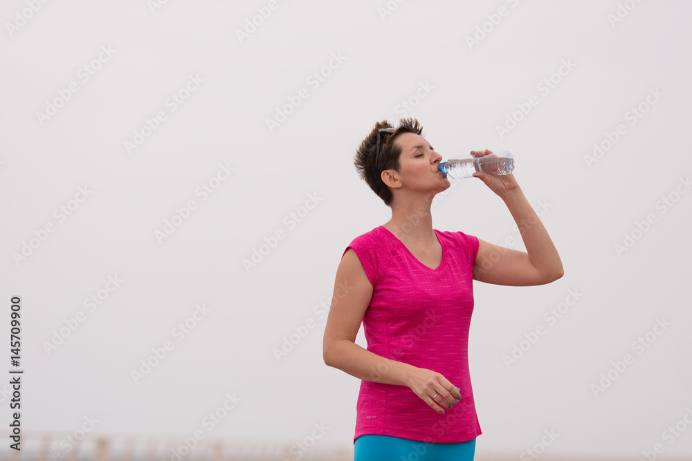 Fitness woman drinking water Fitness woman drinking water