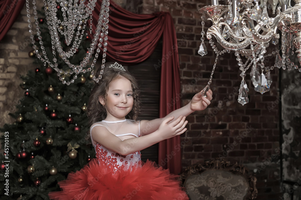 Φωτογραφία Little girl in red princess dress and chandelier with crystal