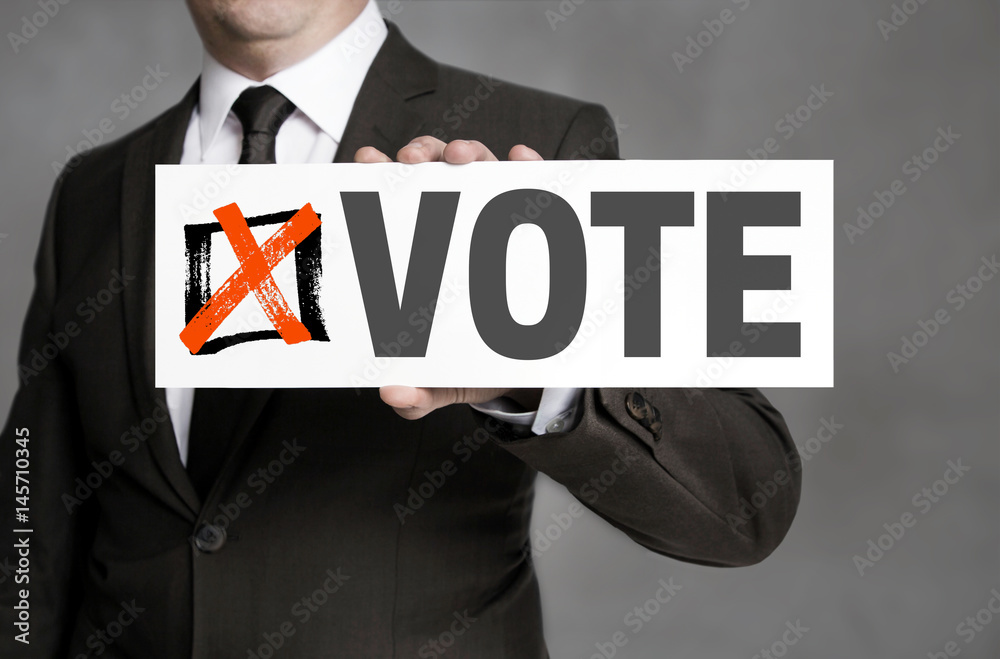 Vote sign is held by businessman Vote sign is held by businessman