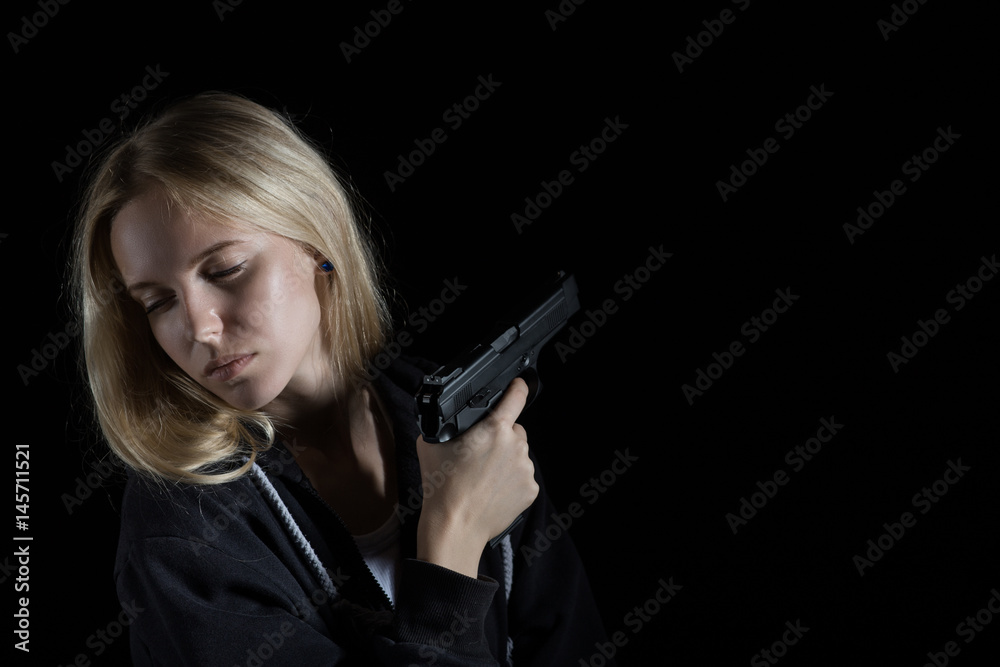 serious girl with gun on black background with copy space serious girl with gun on black background with copy space