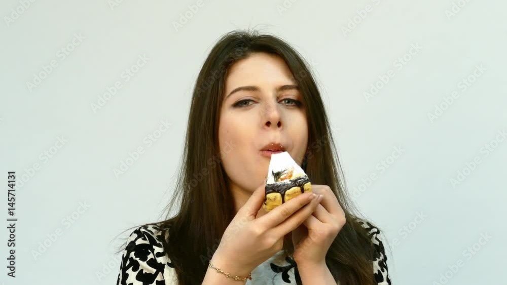 Young brunette Woman Eating the Cake Young brunette Woman Eating the Cake
