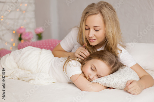 mother put her daughter to sleep. Interior. Concept care