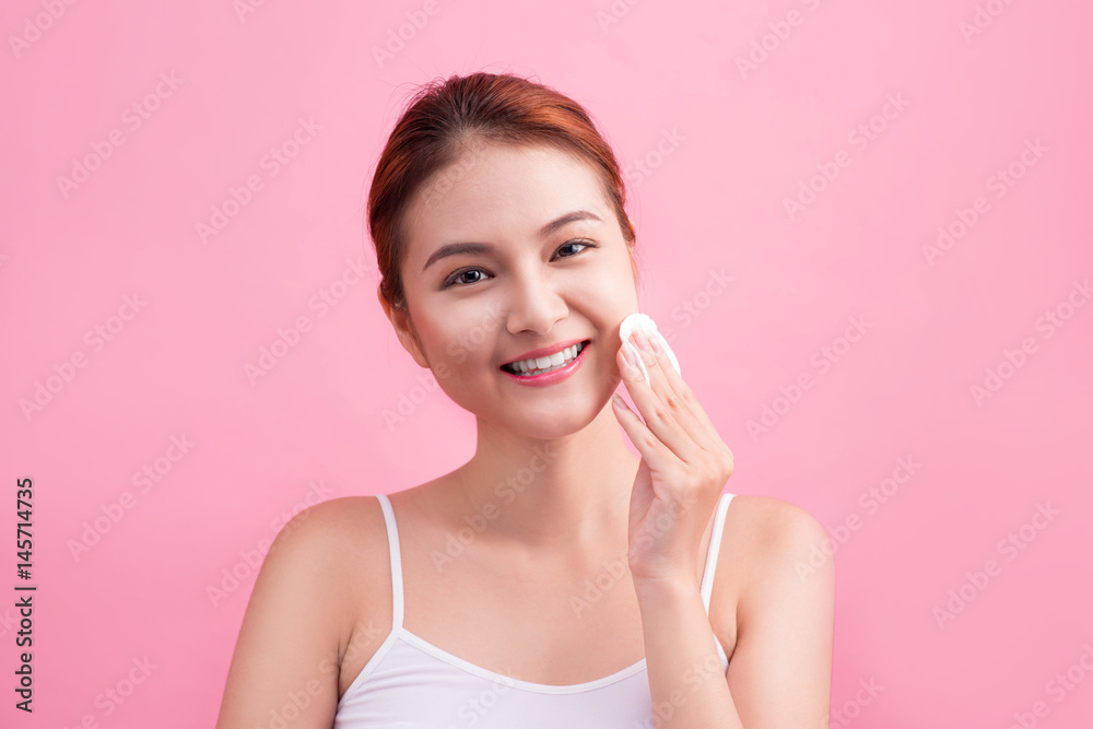 Healthy fresh asian girl removing makeup from her face with cotton pad. Healthy fresh asian girl removing makeup from her face with cotton pad.
